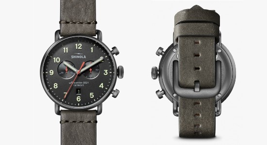 A front and back image of a gray shinola watch with a gray strap and dial