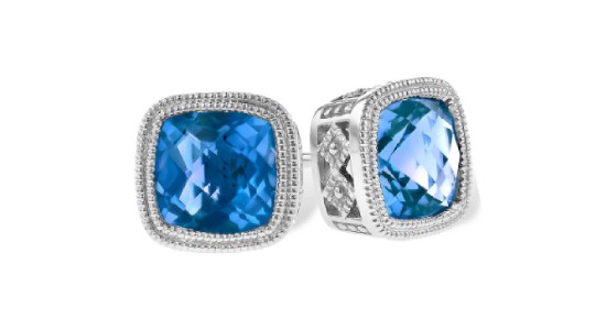 a silver pair of stud earrings featuring blue topaz gemstones.