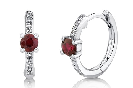 A pair of ruby huggies earrings from Shy Creation also feature diamond accents.