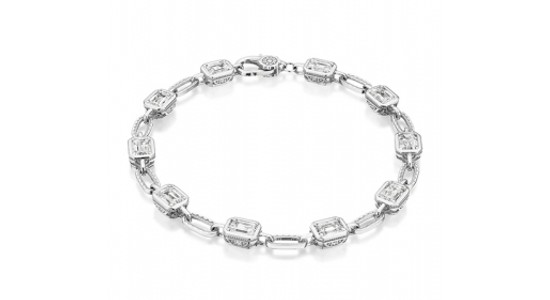 a white gold diamond bracelet featuring bezel set, baguette cut