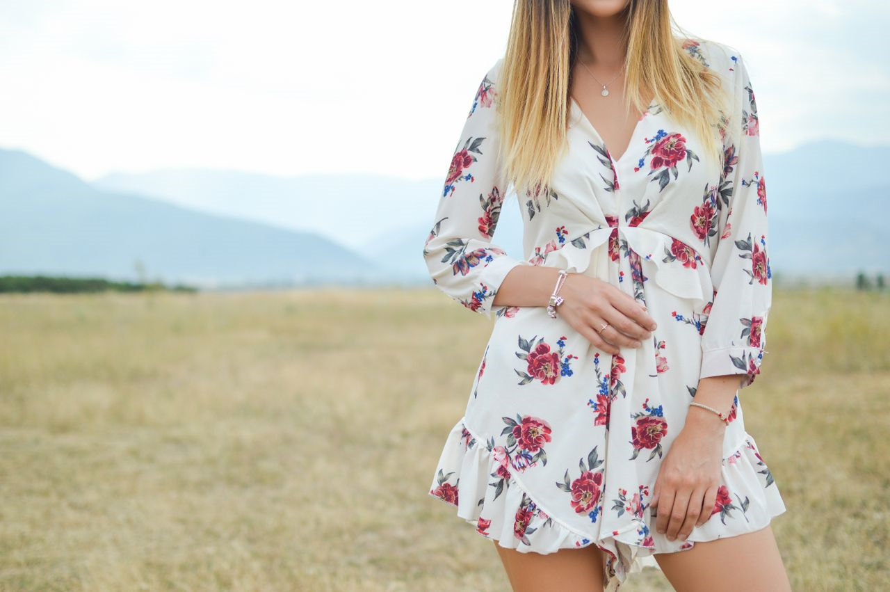 lady standing in a field wearing bracelets