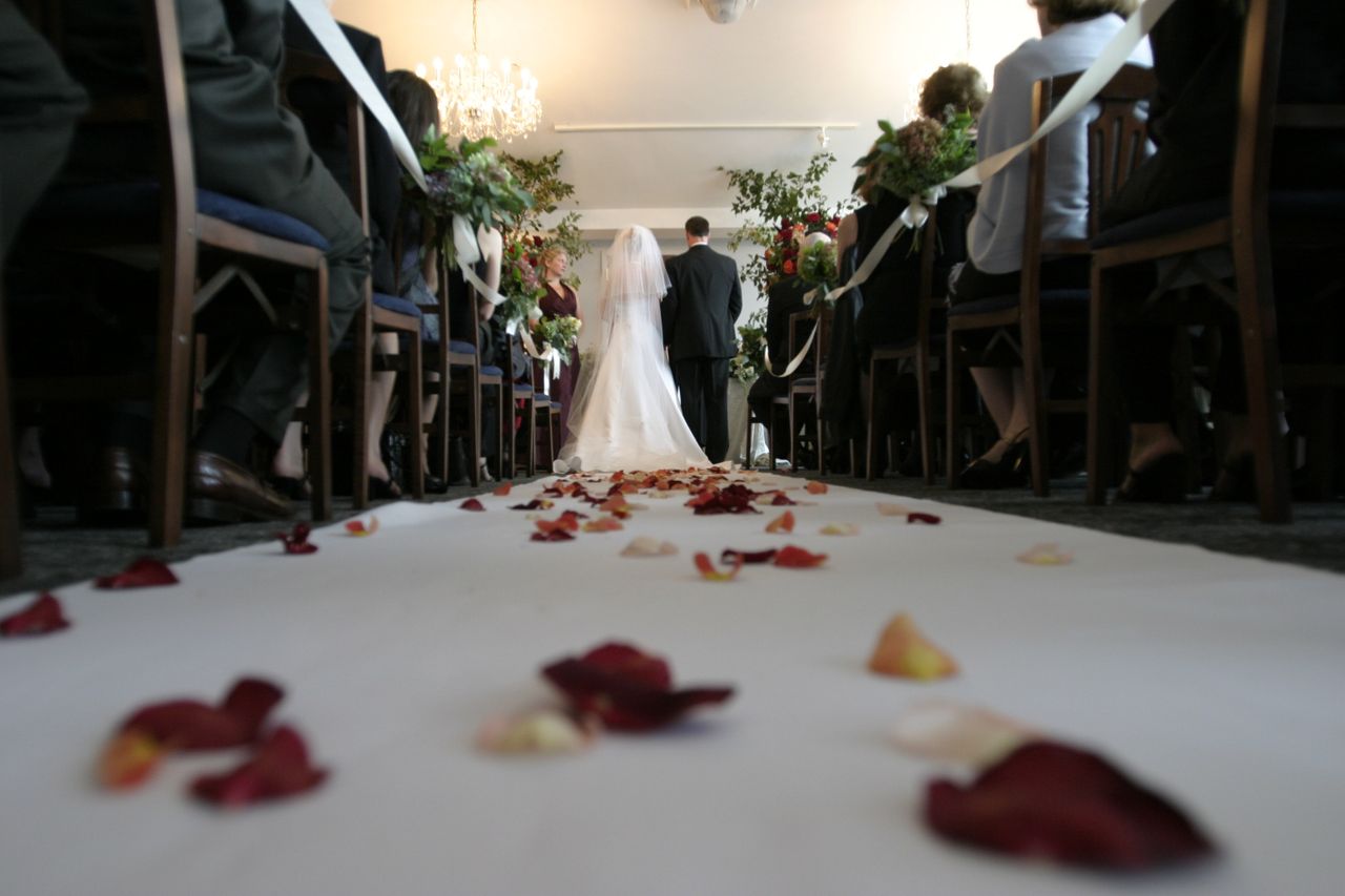 A bride and groom stand at the altar at a wedding ceremony.